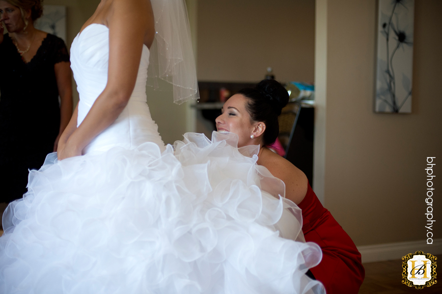 Bride puts on dress